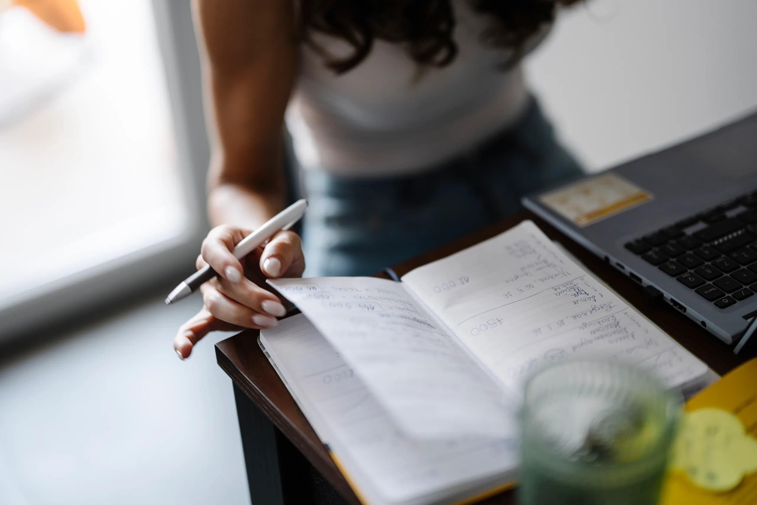 Notes being written at a desk as a trip takes shape